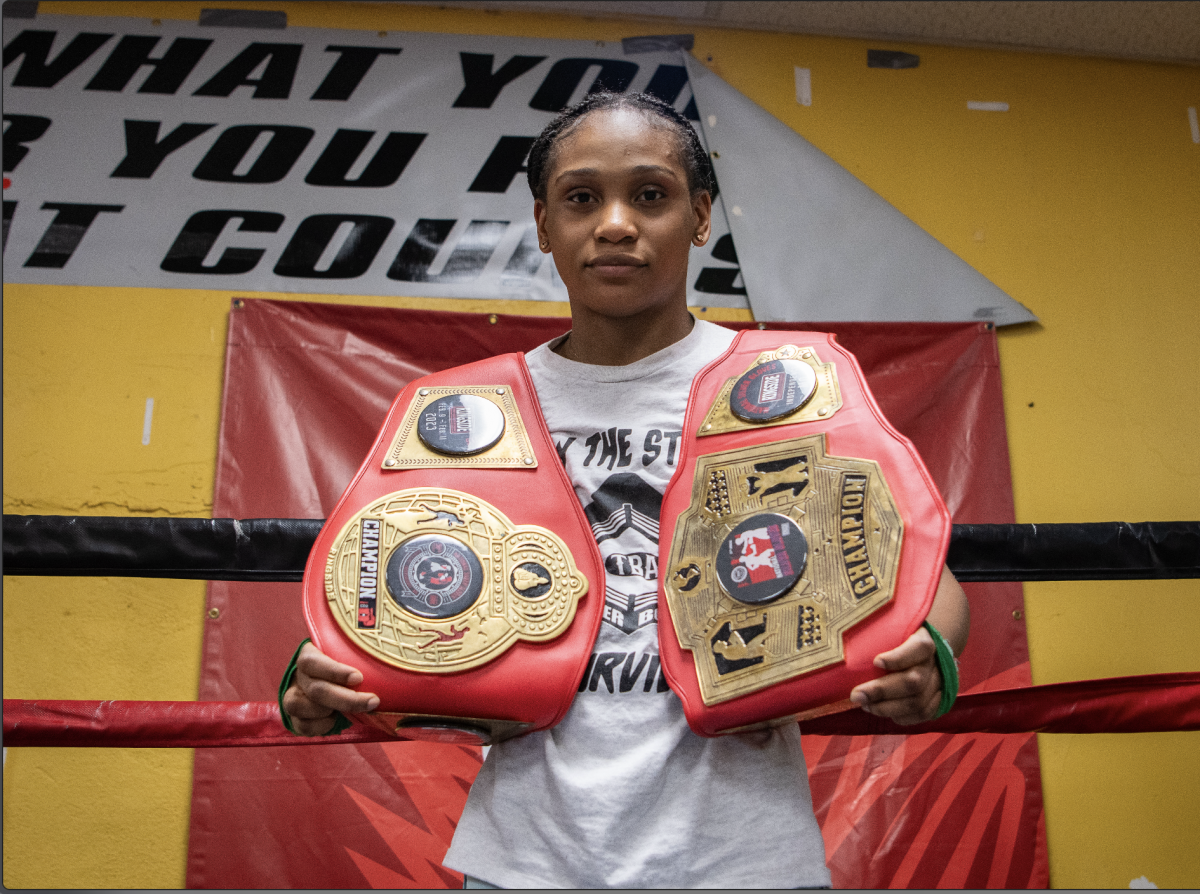 8th Grader Callista Ndubuisi holds her boxing championship belts March 28 at Turner Boxing Academy. Photo by Kara Simpson